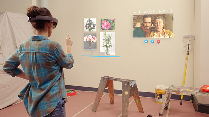 A person wearing a HoloLens using Skype for HoloLens.